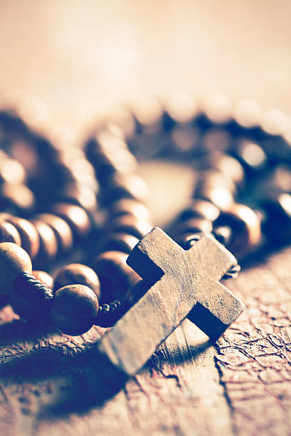 istock rosary on old wooden table 589549682