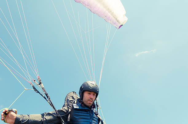 istock Low angle of male paraglider holding ropes 589550252