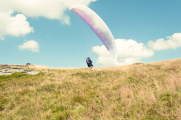 istock One paraglider on a summer blue sky taking off 589550500