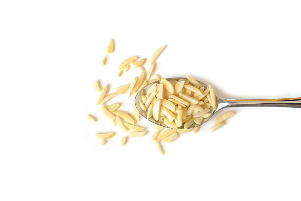 Almond chopped on white background - isolated Almond chopped on white background - isolated almond slivers stock pictures, royalty-free photos & images