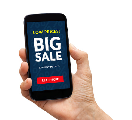 Hand holding a black smart phone with big sale concept on screen. Isolated on white background. All screen content is designed by me.
