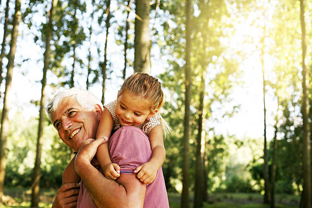 istock Senior man carrying kid. 589552844