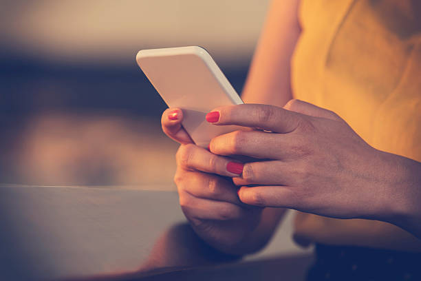 istock Woman using cellphone outdoors. 589552876