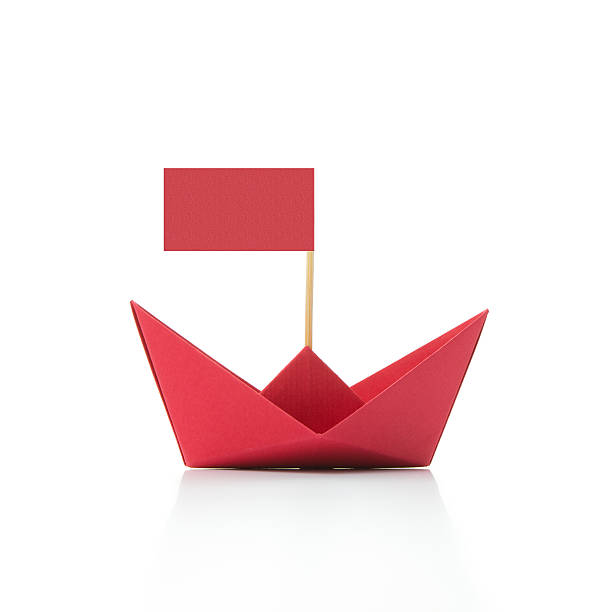 istock Red paper boat with flag 589553644