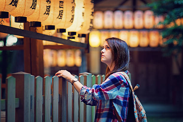 istock Young tourist girl is looking beautiful lanterns 589553738
