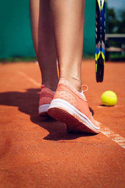 istock Female tennis player legs 589555096