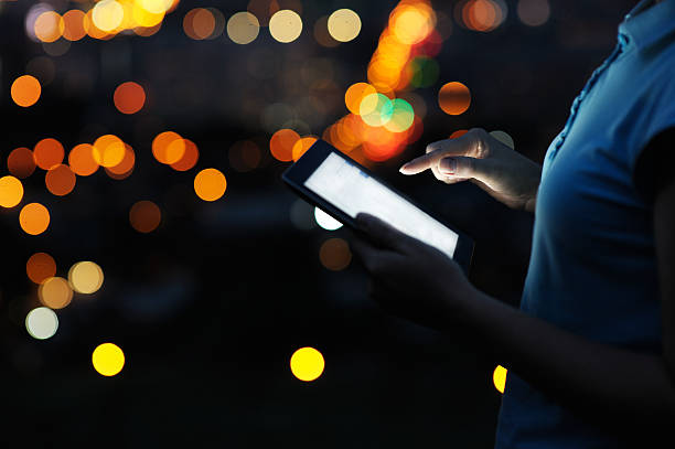 istock Close up woman using digital tablet in the night. 589557986