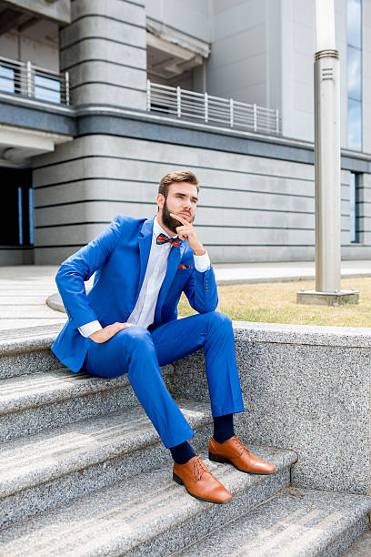 istock Young thoughtful businessman on staircase. 589558020