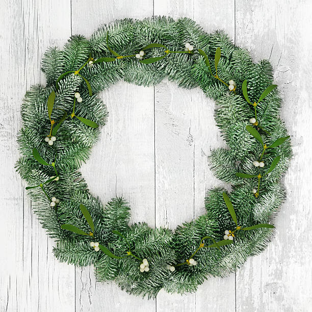 istock Christmas Spruce Fir and Mistletoe Wreath 589559018