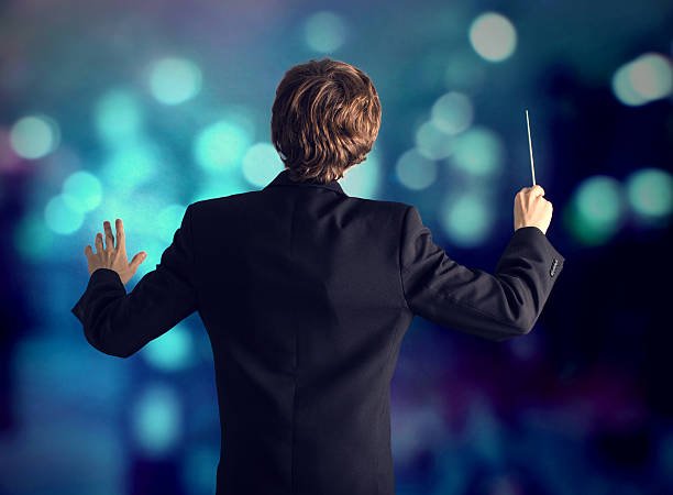 The conductor of the orchestra. Man conducting an orchestra musical conductor photos stock pictures, royalty-free photos & images
