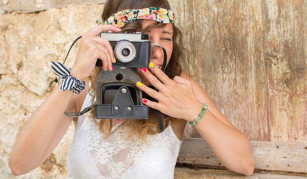 istock Girl with vintage camera in a old town 589559392