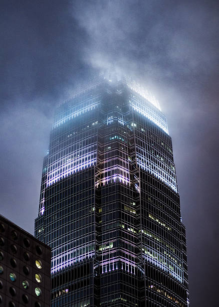 International Commerce Center Hong Kong, Hong Kong - September 2, 2013: Close up view of the International Commerce Center in Hong Kong being covered by fog. international commerce center stock pictures, royalty-free photos & images