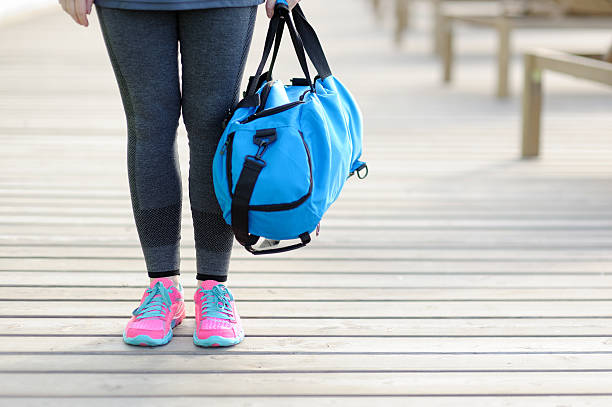 women with a blue sports bag. before training. - gym bag imagens e fotografias de stock