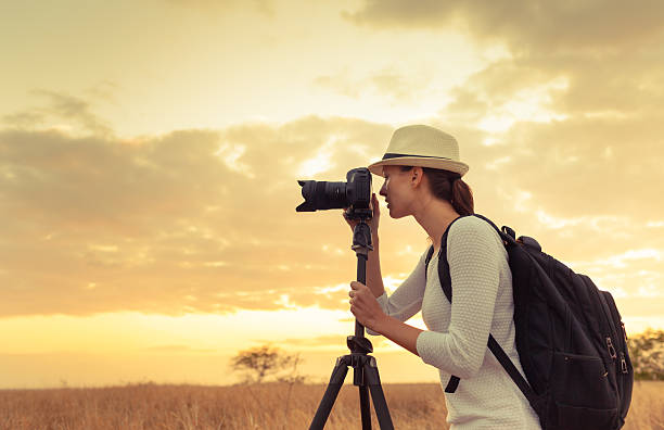 istock Female photographer taking pictures 589560930