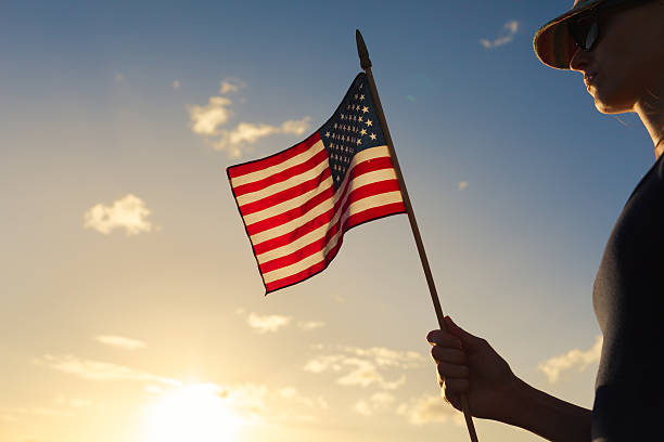 istock Girl holding USA flag 589562650