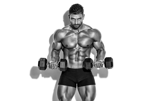 Handsome Muscular Men Exercise With Weights. Black and White Image. Copy Space