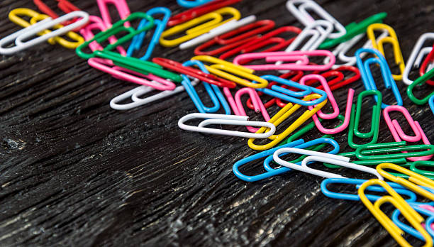 istock Colorful clips on wooden background 589565758
