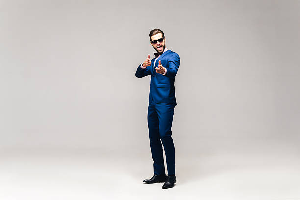 Choosing you. Full length studio shot of handsome young smiling man in full suit and bow tie looking at camera and gesturing i want you stock pictures, royalty-free photos & images