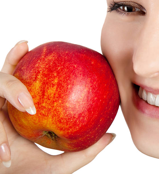 istock smiling woman with apple 589568204