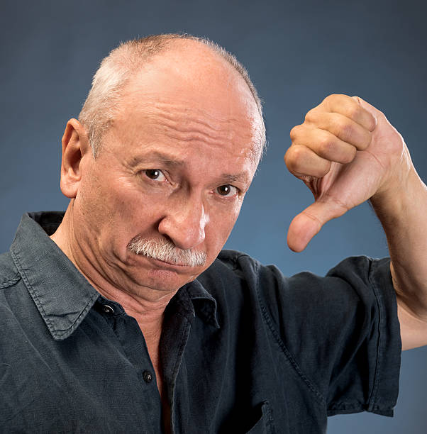 istock Thoughtful senior man showing negative sign 589568326