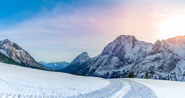istock Alpine panorama with  snowy road 589569130