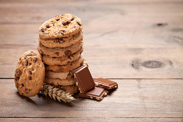 istock Cookies tower and chocolate on old wooden table. 589569866