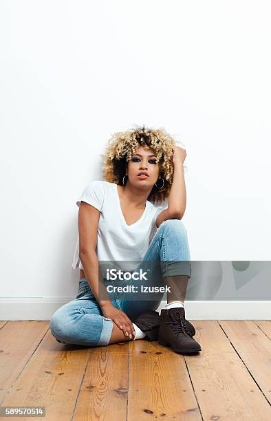 Portrait Of Afro American Young Woman Stock Photo - Download Image Now - Flooring, Full Length, Multiracial Person