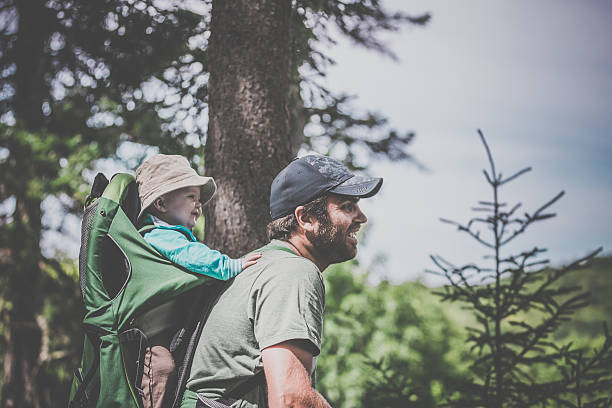 istock Father Backpacking Hiking with Baby in Forest 589570972
