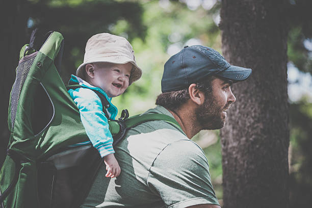 istock Father Backpacking Hiking with Baby in Forest 589571144