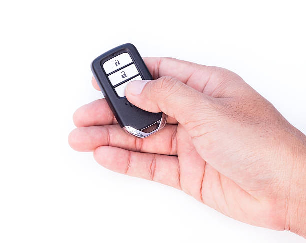istock Hand with a car key on white background. 589572588