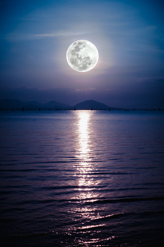 Fantastic view of the sea. Romantic scenic with full moon on sea to night. Reflection of moon in water. The moon were NOT furnished by NASA.