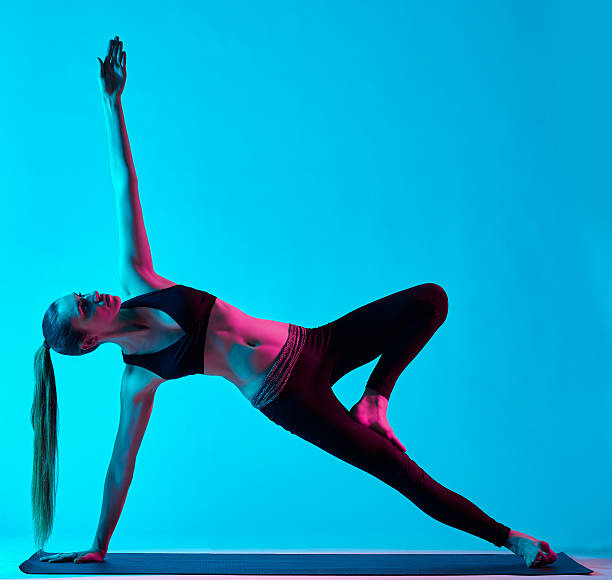 istock woman yoga exercises 589574056