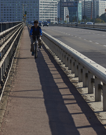 Seoul, Republic of Korea - September 27, 2015: Korean asian man riding bicycle on the bridge.