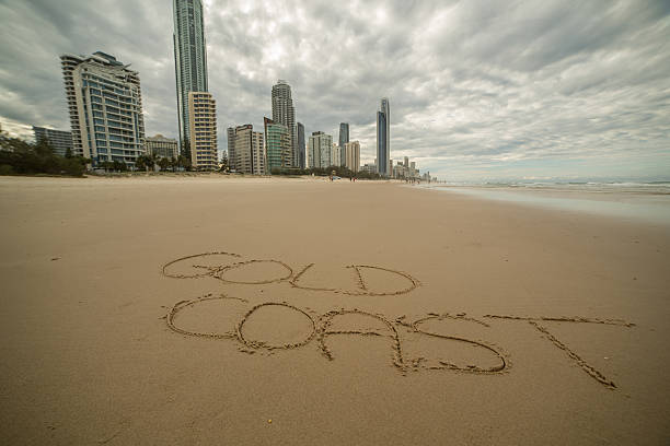 Surfer's paradise beach, Gold coast handwriting on sand. City skyline on the background.qqa