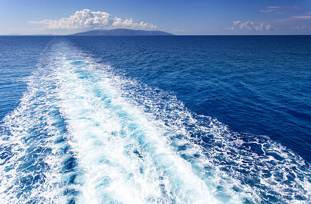 istock Trail on water surface behind of cruise ship 589576494