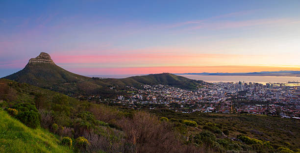 Cape Town city bowl and Lion's Head at sunrise Beautiful View of Cape Town city bowl, Lion's Head mountain and distant ocean at sunrise signal hill stock pictures, royalty-free photos & images