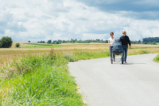 istock Grandparents going for a walk with granchild in baby stroller 589578046