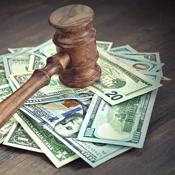 Heap Of Dollars With Judges Or Auctioneers Gavel Or Hammer stock photo