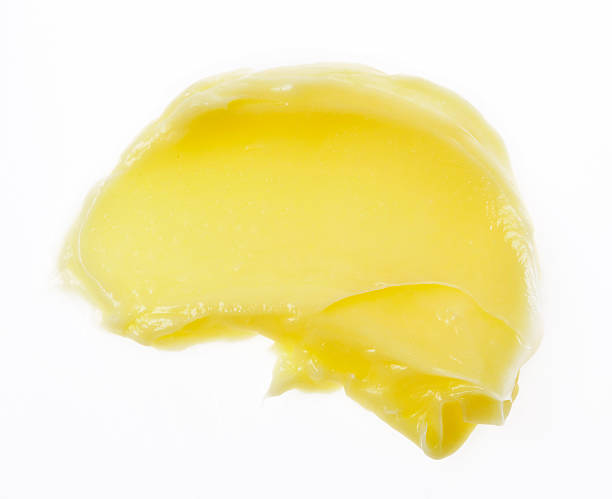 istock Yellow color skincare balm on background 589579156