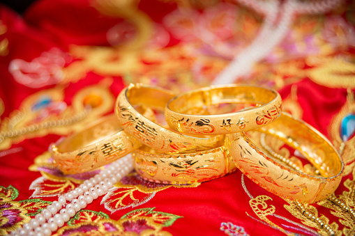 Golden wedding bracelets with traditional Chinese wedding gown