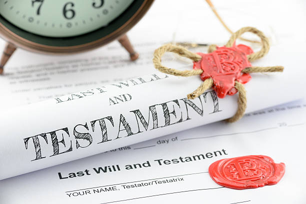 Rolled up scroll of last will and testament. Rolled up scroll of last will and testament fastened with natural brown jute twine hemp rope, sealed with sealing wax and stamped with alphabet letter B. Decorated with an antique clock on a table. probate photos stock pictures, royalty-free photos & images