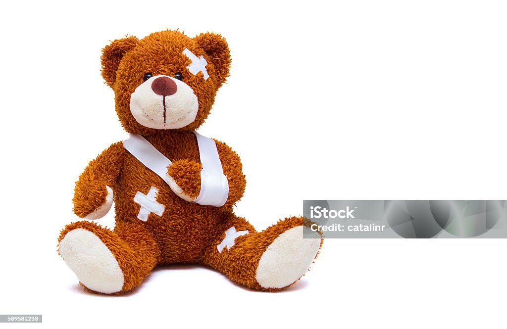 Injured teddy bear on white background Adhesive Bandage Stock Photo