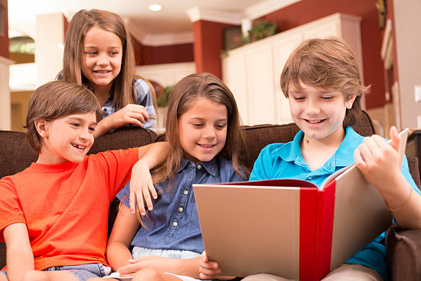 istock Children at home reading books together. 589583050