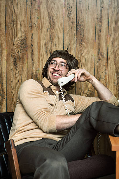 istock Relaxed Shaggy Nerd on Telephone 589584056