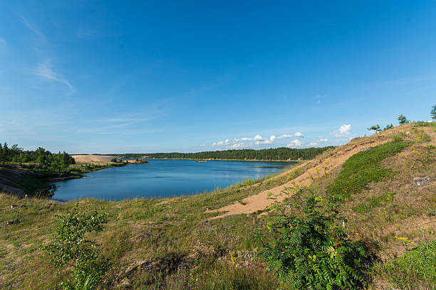 istock Blue lake and blue sky with clouds. Summer landscape. 589584136
