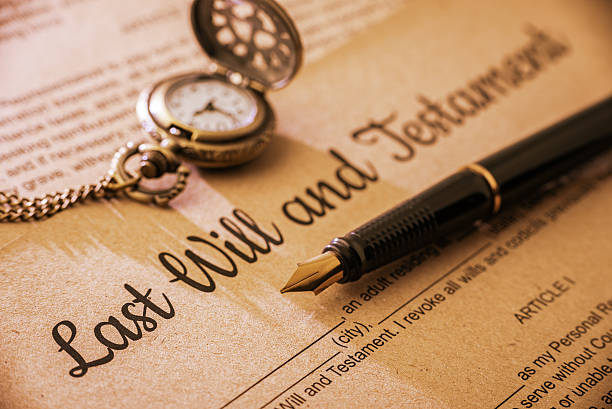 Fountain pen, pocket watch on a last will and testament. Vintage / retro style with a long shadow : Fountain pen, a pocket watch on a last will and testament. A form is printed on a mulberry paper and waiting to be filled and signed by testator / testatrix. last stock pictures, royalty-free photos & images