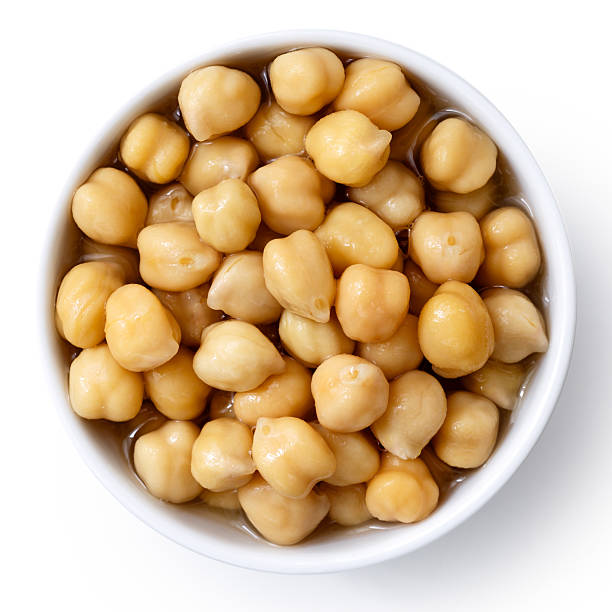 istock Cooked chickpeas in white bowl isolated on white from above. 589585504