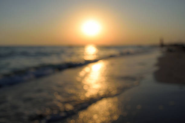 istock sunset on the beach, out of focus 589938124