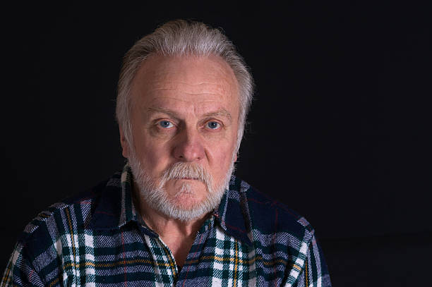 Portrait of grey-bearded Caucasian man with hard look - fotografia de stock