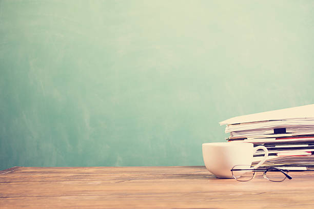 coffee mug, papers stacked on teachers school desk with chalkboard. - blackboard back to school green picture frame imagens e fotografias de stock